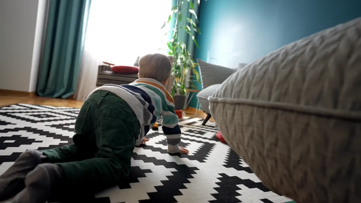A young child on a living room floor, illustrating why indoor air quality matters for families