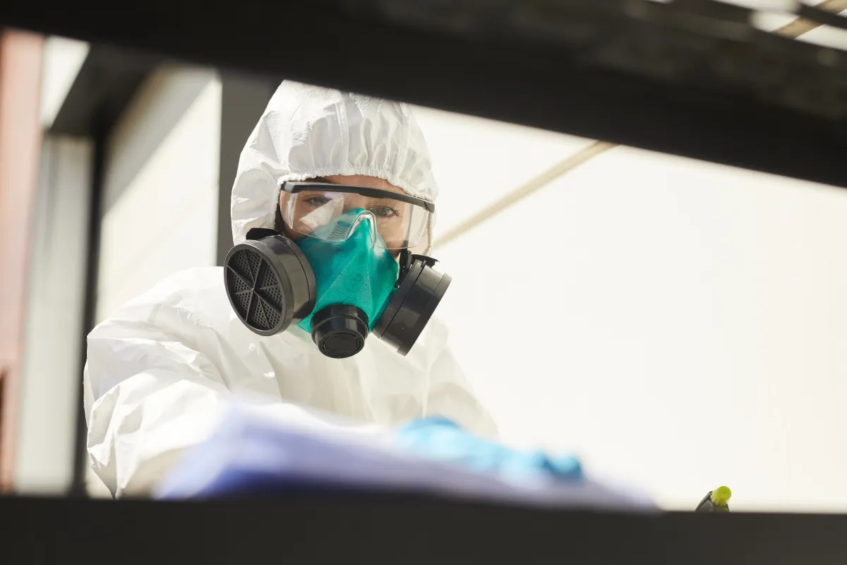 A technician applying antimicrobial surface treatment, illustrating professional HVAC mold treatment